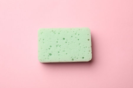 One kitchen sponge on pink background, top viewの写真素材