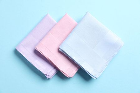 Different pastel color handkerchiefs on light blue background, flat layの写真素材