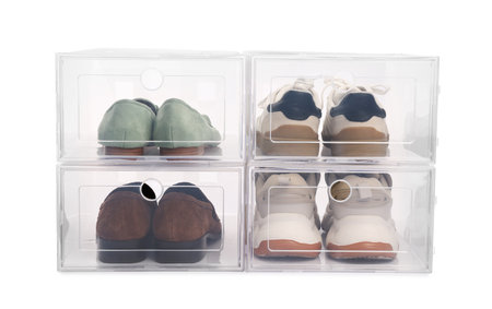 Many pairs of beautiful shoes in plastic boxes on white background. Storage and organization