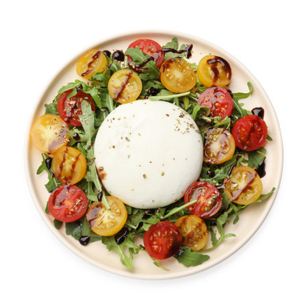 Delicious burrata cheese with arugula, tomatoes and dressing isolated on white, top view