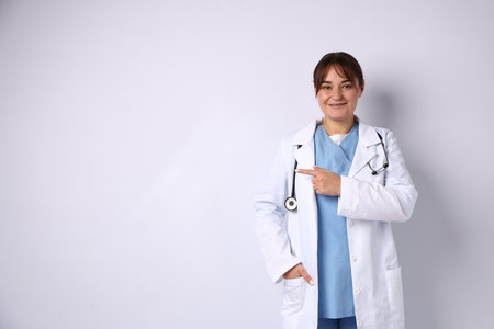 Doctor in medical uniform with stethoscope on white backgroundの写真素材