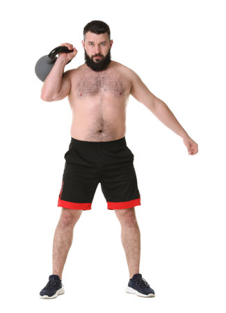 Man exercising with kettlebell on white backgroundの写真素材
