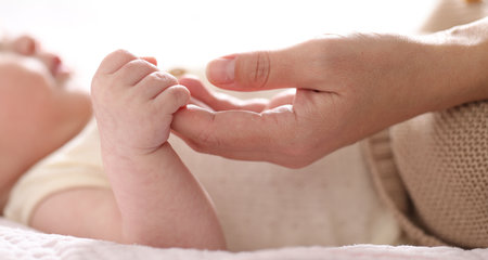 Mother with her cute newborn baby indoors, closeupの写真素材