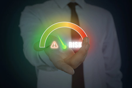 Man holding virtual scale of risk against black background, closeupの写真素材