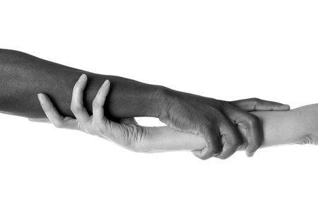 Man and woman holding hands together, closeup. Black-and-white toning
