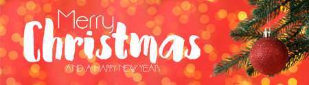 Merry Christmas and Happy New Year. Greeting card with fir tree, festive ornament and bokeh lights on red backgroundの写真素材