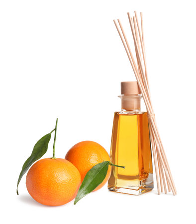 Citrus scented reed diffuser and fresh tangerines isolated on whiteの写真素材