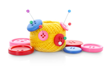 Ball of bright knitting yarn with buttons and pins isolated on white