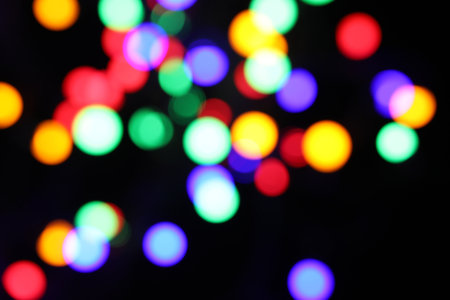 Blurred view of bright lights on dark background, bokeh effectの写真素材