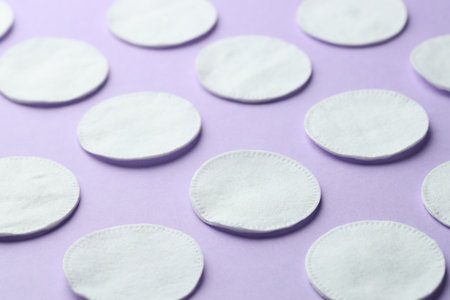 Clean cotton pads on lilac background, closeupの写真素材