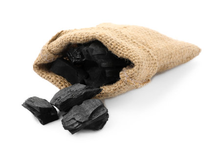 Sack with pieces of black coal on white backgroundの写真素材