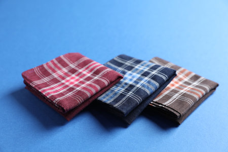 Different stylish fabric handkerchiefs on blue background, closeupの写真素材