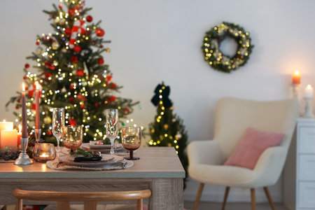 Festive table setting with Christmas decor indoors. Space for textの写真素材