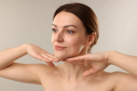 Portrait of beautiful woman on light gray backgroundの写真素材