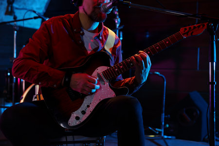 Man playing electric guitar on stage, closeup