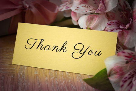 Thank You card, flowers and gift box on wooden table, closeupの写真素材