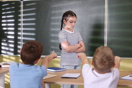Girl getting bullied by her classmates in school, selective focusの写真素材