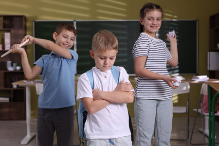 Boy with his classmates in school, selective focus