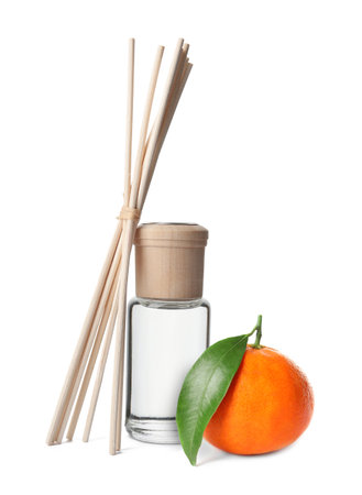 Citrus scented reed diffuser and fresh tangerine isolated on whiteの写真素材