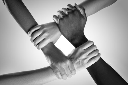 Group of people holding their hands together, top view. Black-and-white toningの写真素材