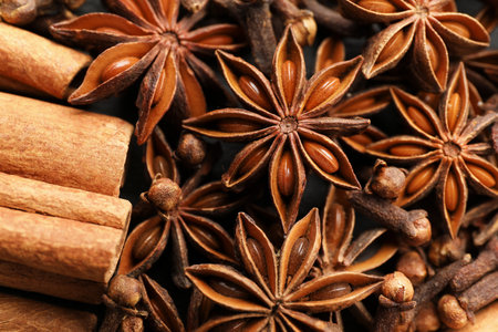 Mulled wine spices. Anise stars, cloves and cinnamon sticks as background, top viewの写真素材