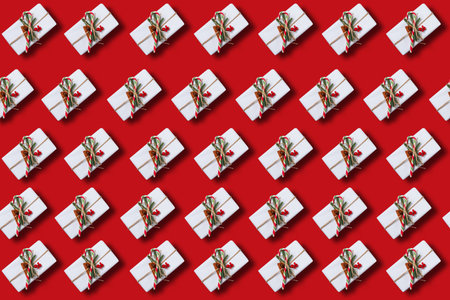 Christmas pattern of beautiful gift boxes on red backgroundの写真素材