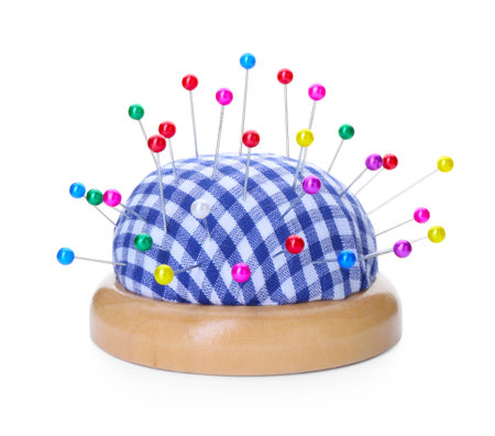 Checkered pincushion with pins isolated on white. Sewing accessoryの写真素材