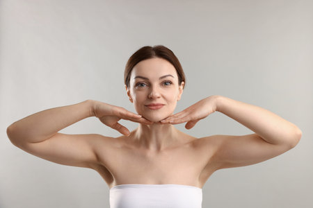 Portrait of beautiful woman on light gray backgroundの写真素材