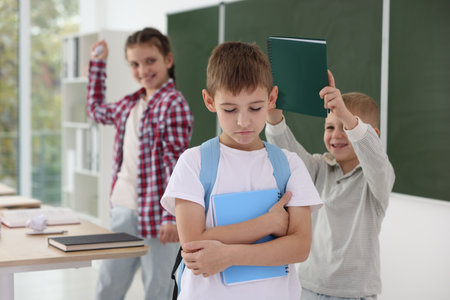 Boy with his classmates in school, selective focus