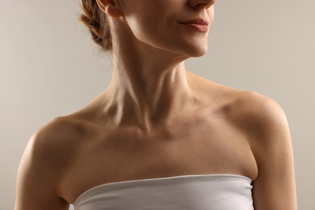 Woman with normal skin on light gray background, closeupの写真素材