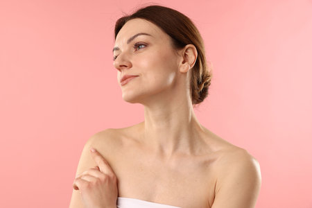 Portrait of beautiful woman on pink backgroundの写真素材