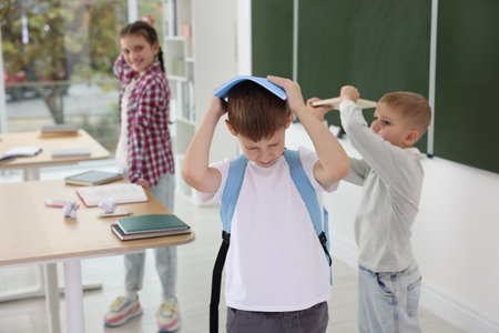 Boy getting bullied by his classmates in school, selective focusの写真素材