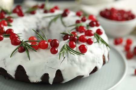 Tasty Christmas cake with cranberries and rosemary on table, closeupの写真素材