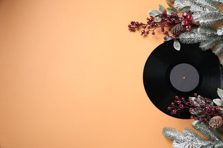 Vinyl record and Christmas decor on beige background, flat lay. Space for textの写真素材