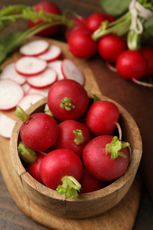 Fresh radishes in bowl on wooden table, closeupの写真素材