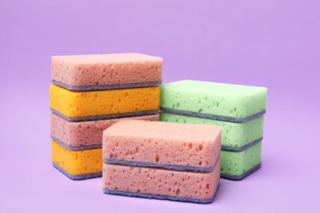 Different kitchen sponges on violet background, closeupの写真素材