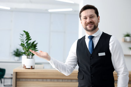Receptionist welcoming near reception desk in hotelの写真素材
