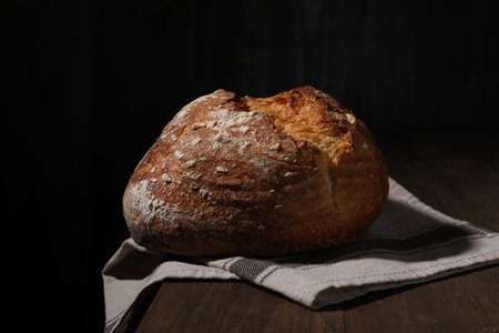 Delicious fresh bread loaf on wooden table, closeupの写真素材