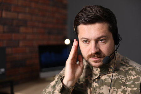 Military service. Soldier in headset working in office, space for textの写真素材