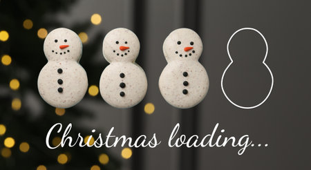 Christmas loading, expectation of holiday. Snowman macarons against blurred background with bokeh lightsの写真素材