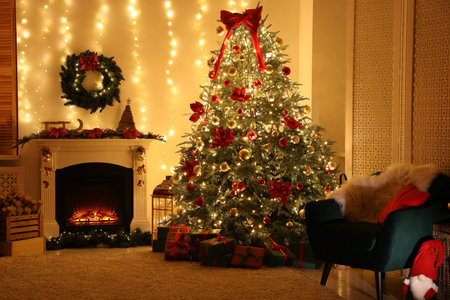 Beautiful fireplace, Christmas tree and festive decor in cozy room. Interior designの写真素材