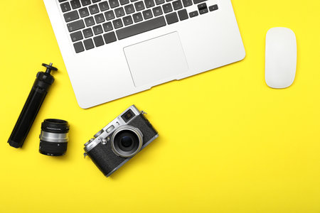 Professional photographer's equipment on yellow background, flat layの写真素材