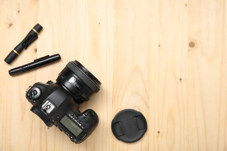 Professional photographer's equipment on wooden background, flat lay. Space for textの写真素材