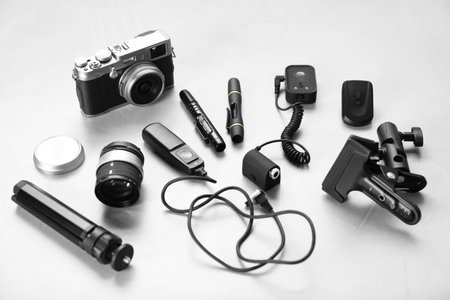Different professional photographer's equipment on light background