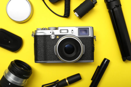 Professional photographer's equipment on yellow background, flat layの写真素材