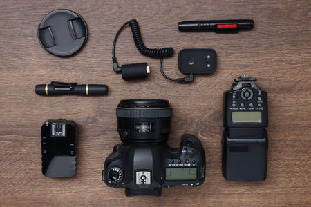 Professional photographer's equipment on wooden table, flat layの写真素材