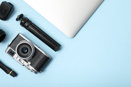 Professional photographer's equipment on light blue background, flat lay. Space for textの写真素材