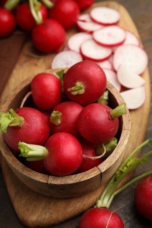Fresh radishes in bowl on wooden table, closeupの写真素材