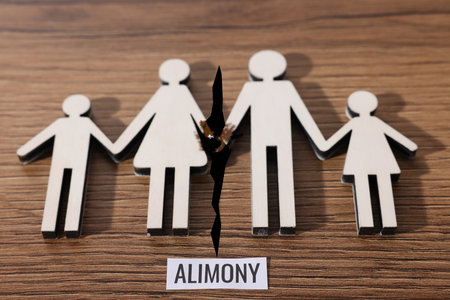 Divorce and alimony concept. Family figure with crack between wife and husband on tableの写真素材