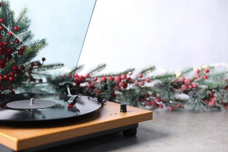 Turntable with vinyl record and Christmas decor on light table, closeup. Space for textの写真素材
